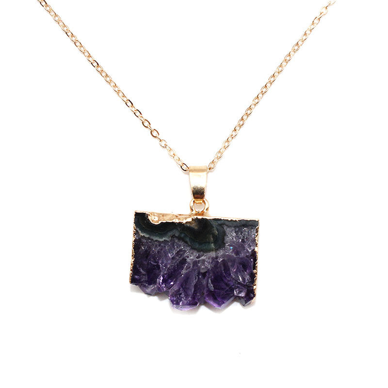 A rose gold chain necklace featuring a raw, polished purple amethyst geode slice pendant with a gold-toned bezel setting, shown against a plain white background.