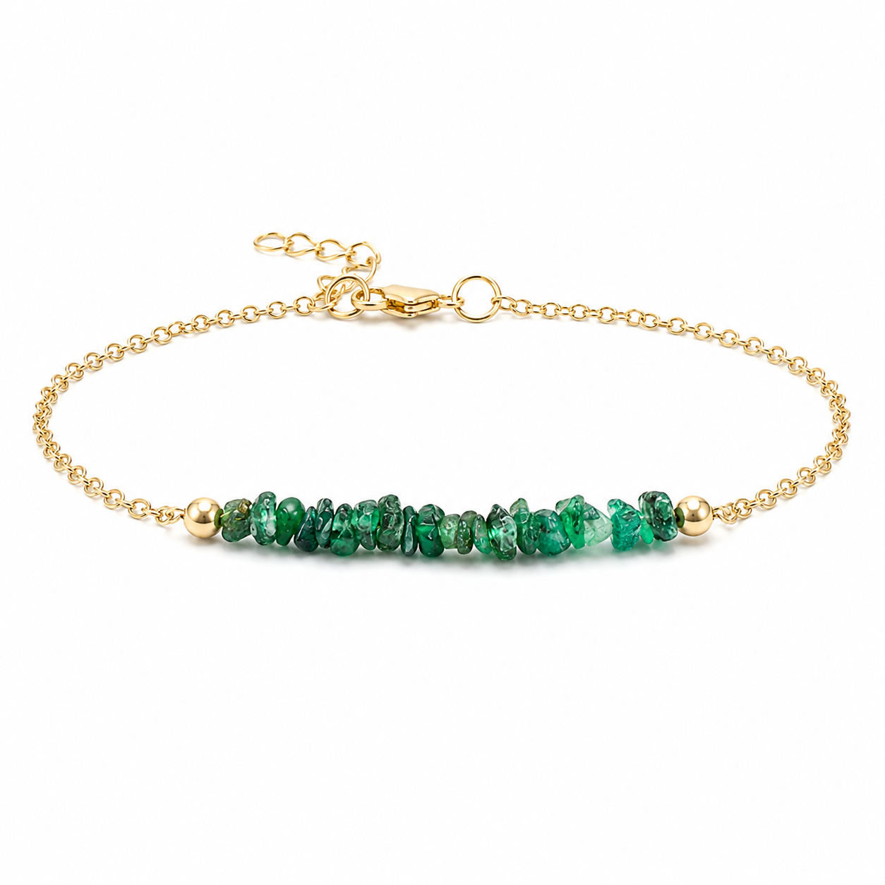Gold chain bracelet featuring natural emerald gemstone chips on a clean white background.