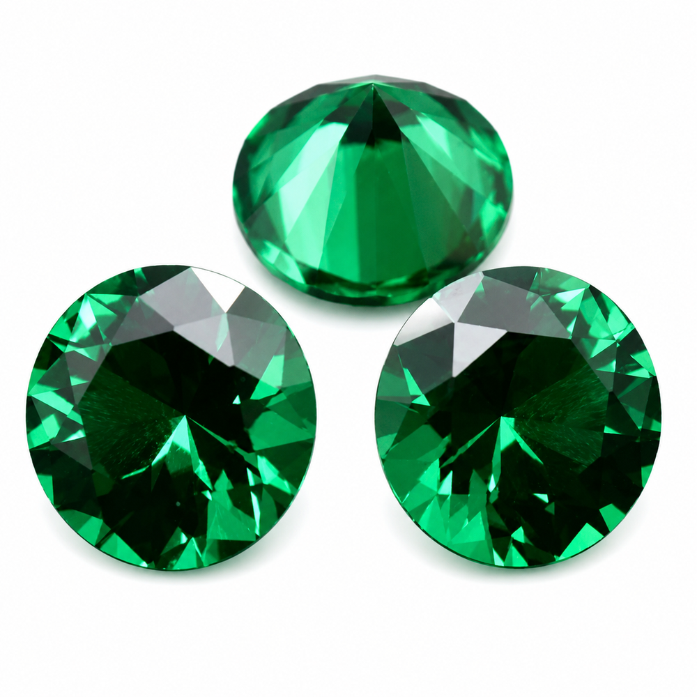 Three round faceted green gemstones arranged on a plain white background, with two stones at the bottom and one centered above them.