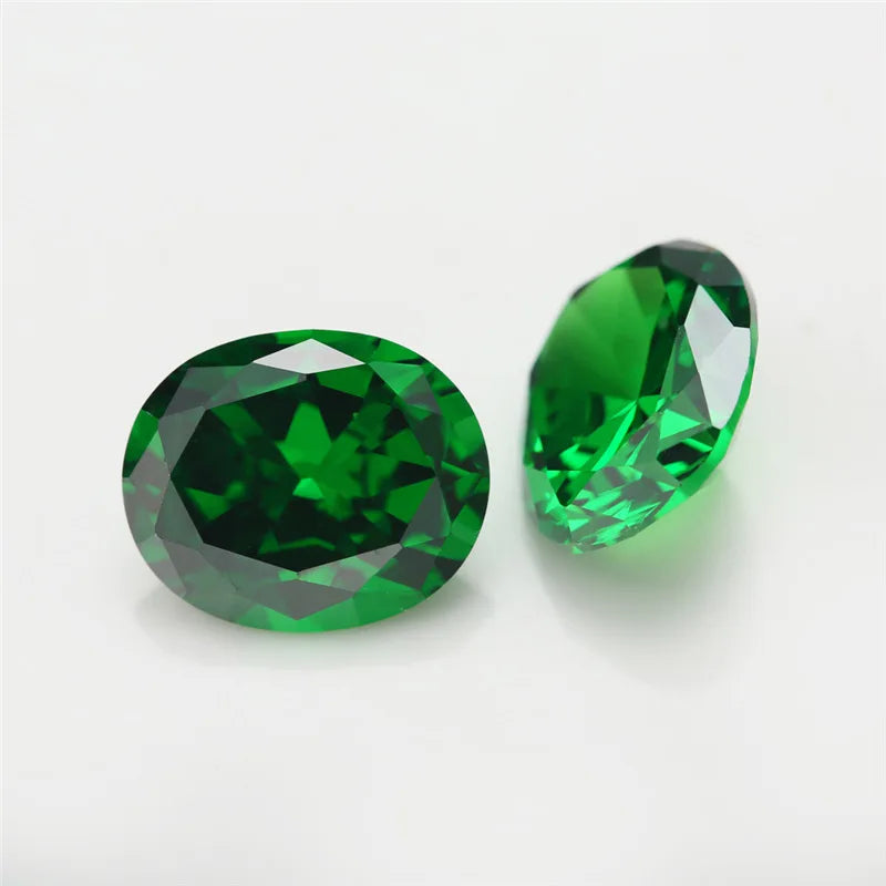 Two oval-cut green gemstones shown on a clean white background, one facing forward and one angled to the side, displaying their faceted facets and rich emerald green color.