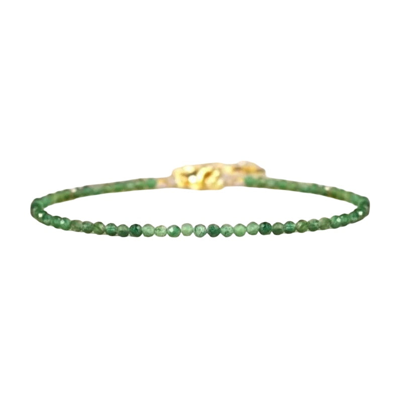 Natural emerald gemstone beaded bracelet with gold clasp on a clean white background.