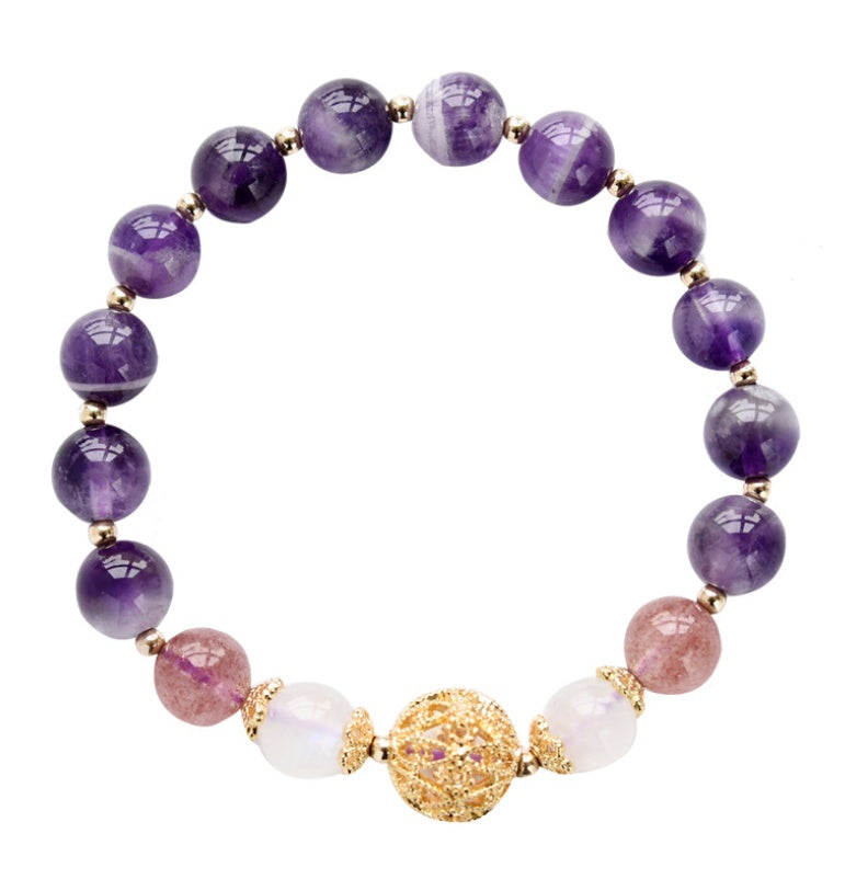 Purple beaded bracelet with gold accents on a white background