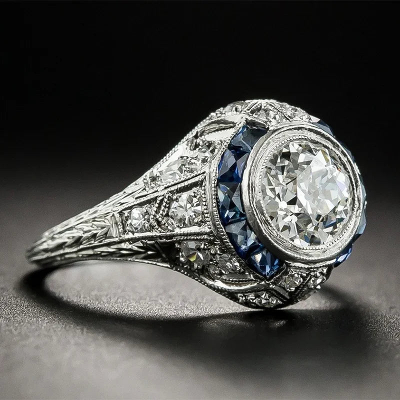 Vintage-style diamond ring with intricate design on a dark background